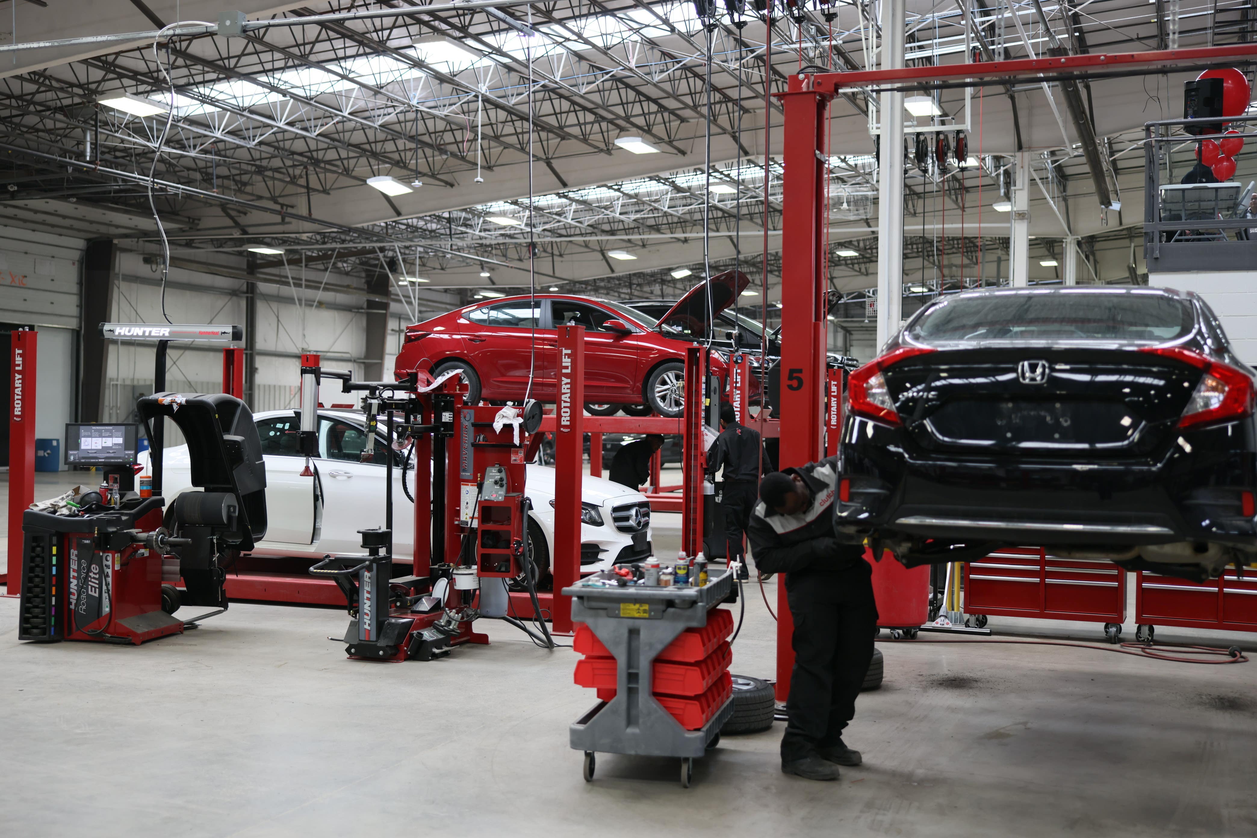 Clutch service facility with vehicles on lifts